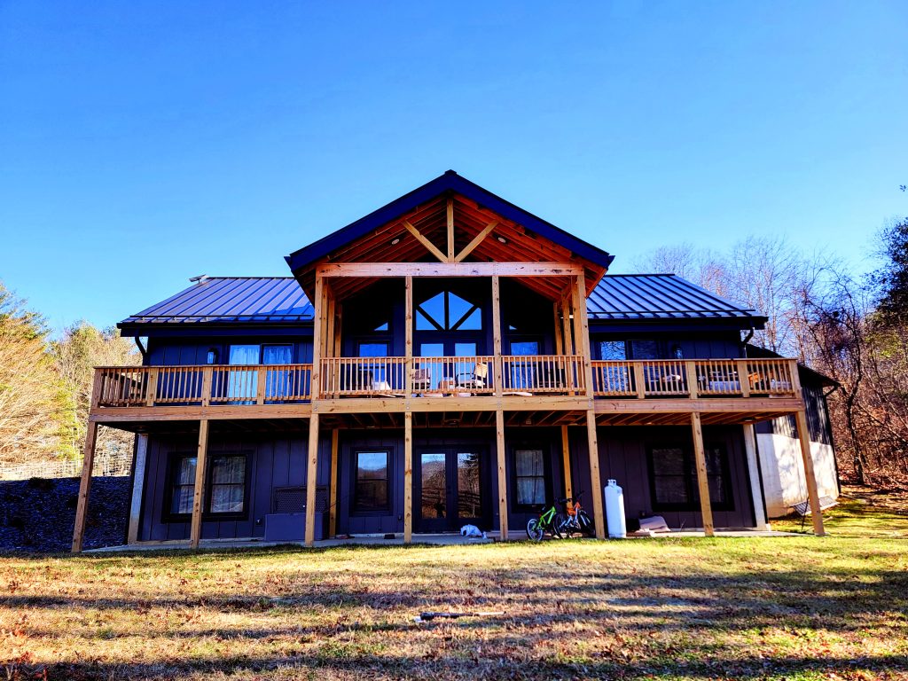 Mountain Sip House.Riner Completed modern mountain home with structural insulated panels (SIPs), exposed timber framing, and elevated wraparound deck engineered by Pinnacle Engineering.