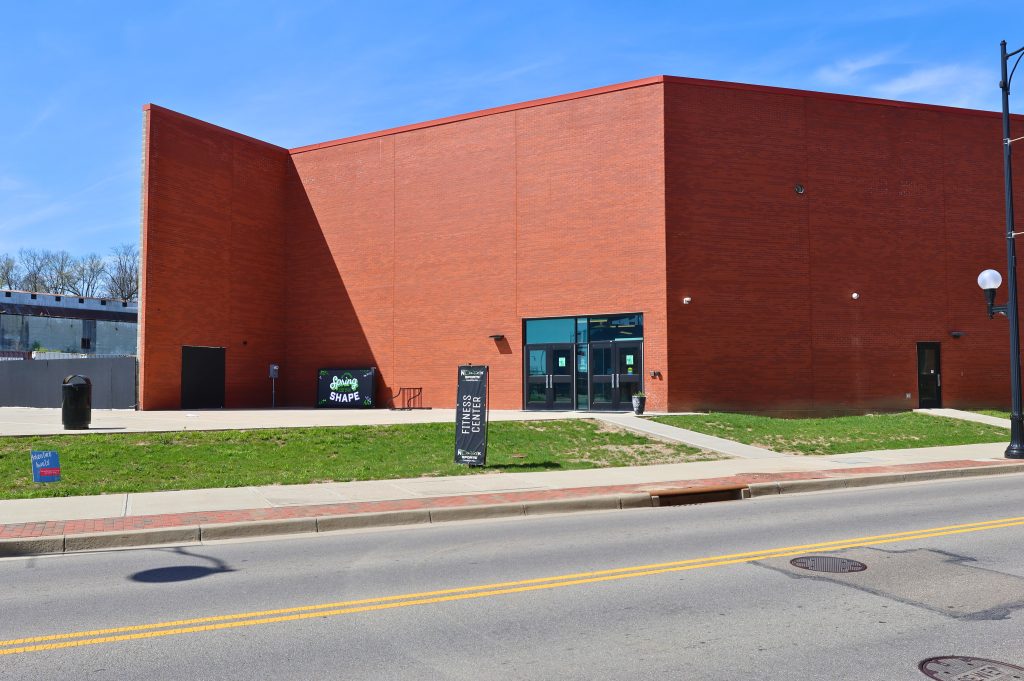 Spooky Hollow Hamilton Oh Fitness Center Entrance Exterior entrance of the Spooky Nook Hamilton Fitness Center, featuring a modern red brick facade and signage for health and fitness programming.